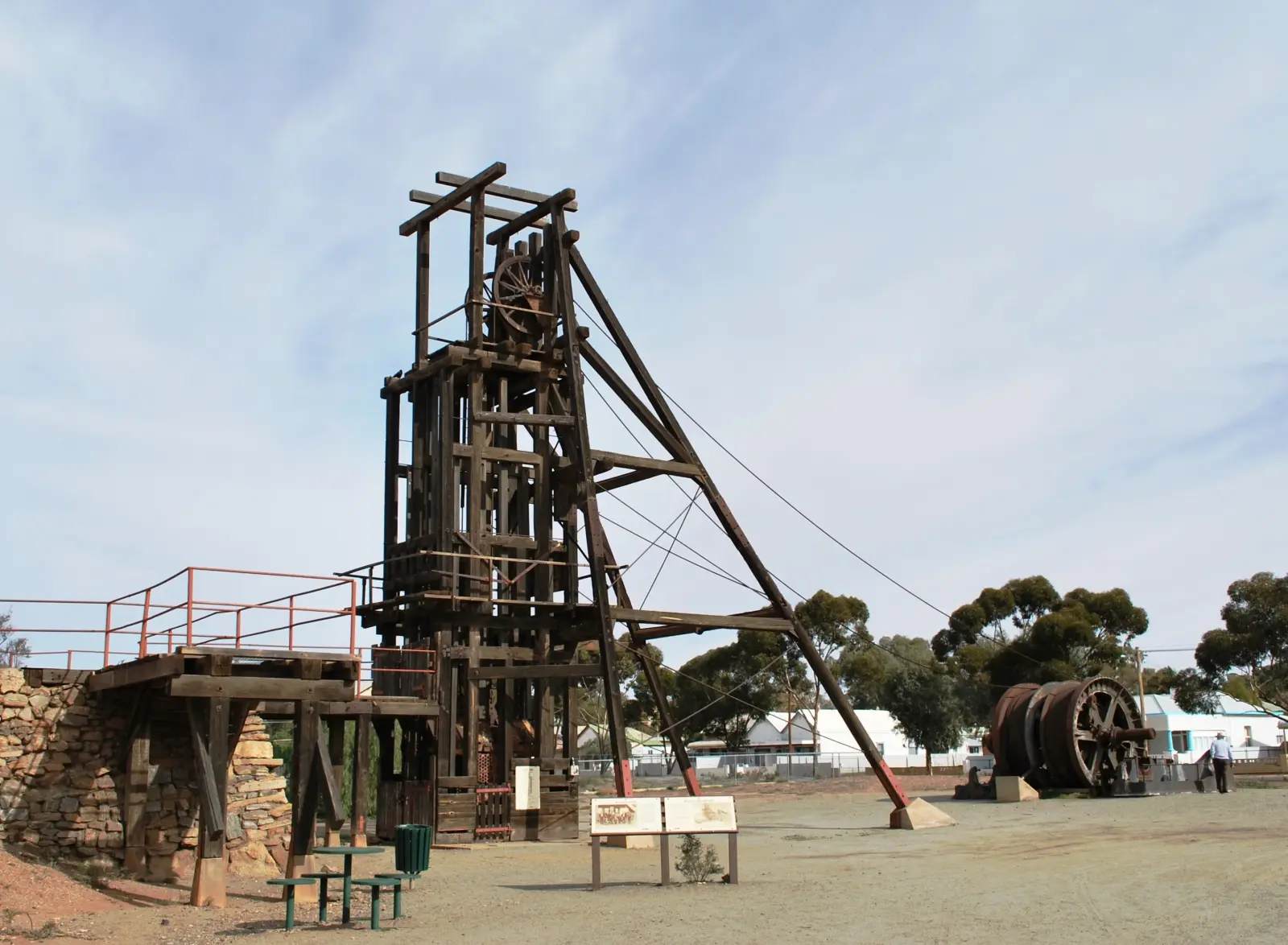 A historic timber mine headframe and winding gear on display at Broken Hill